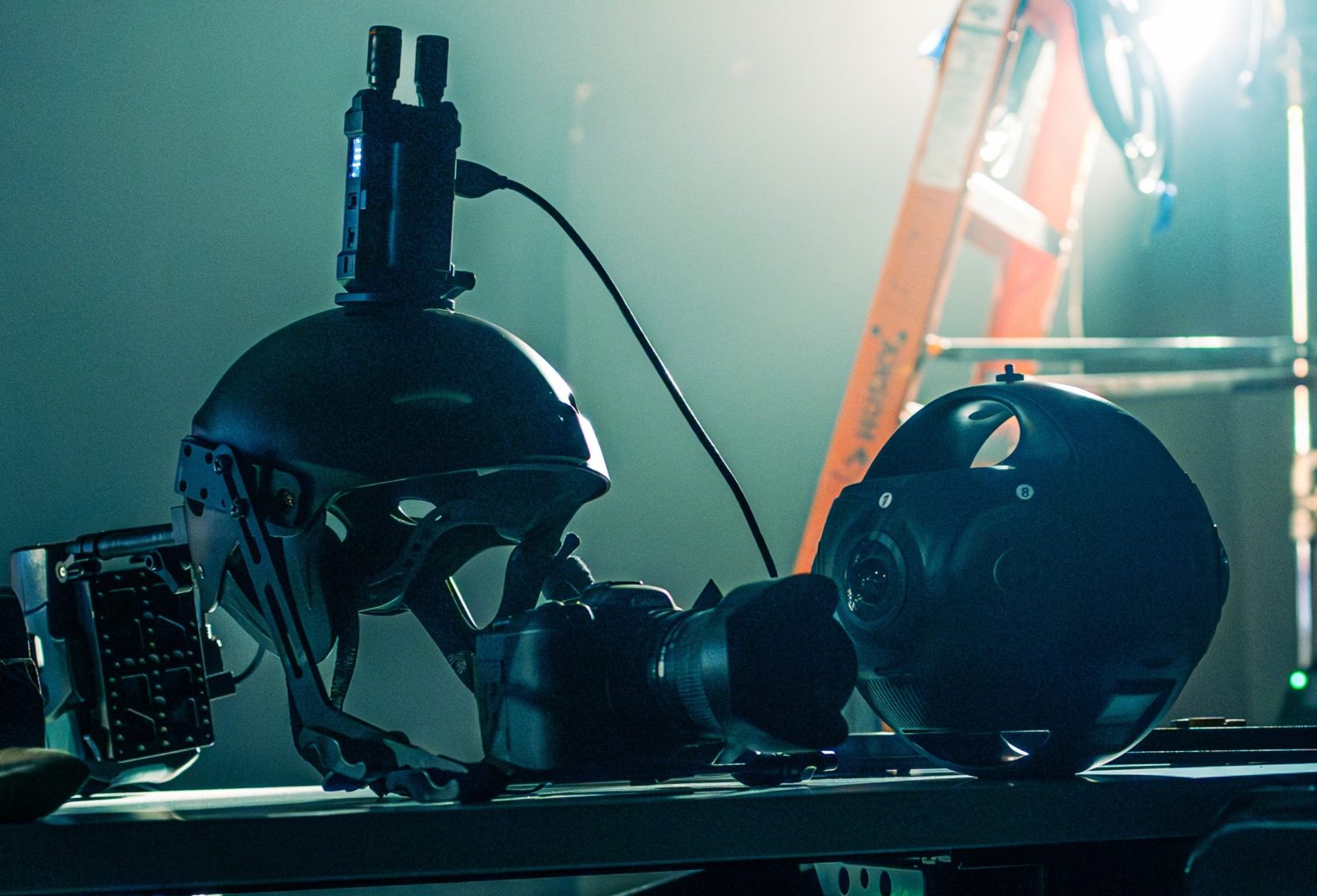 The tools: two Insta360 Titan 360° cameras and a Canon R on the bench